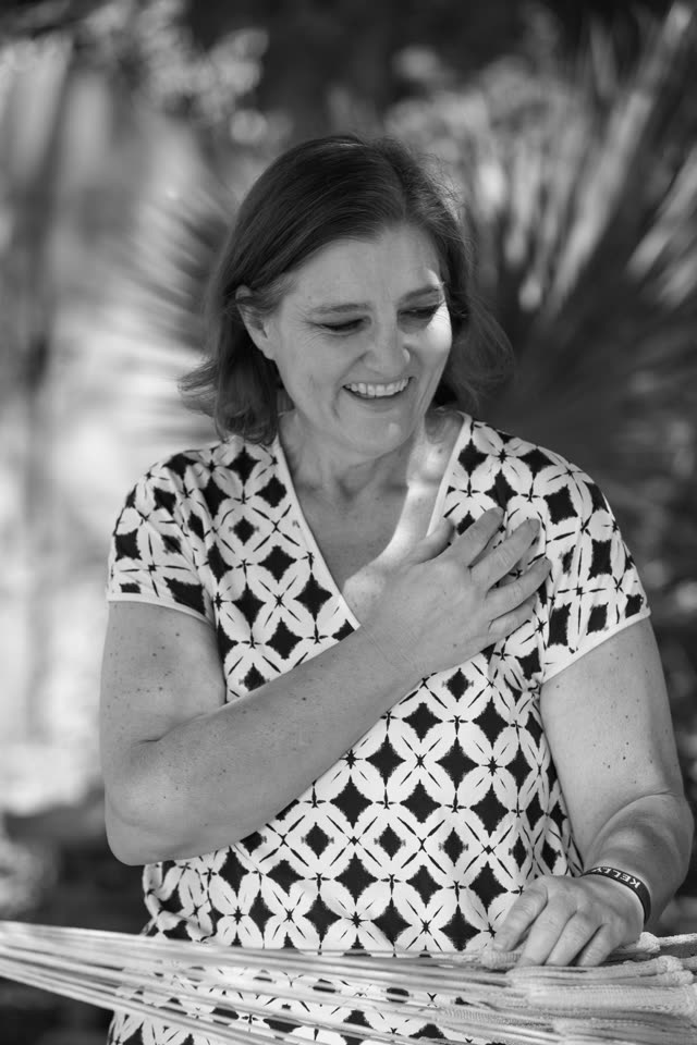 Kelley West, smiling, in black and white